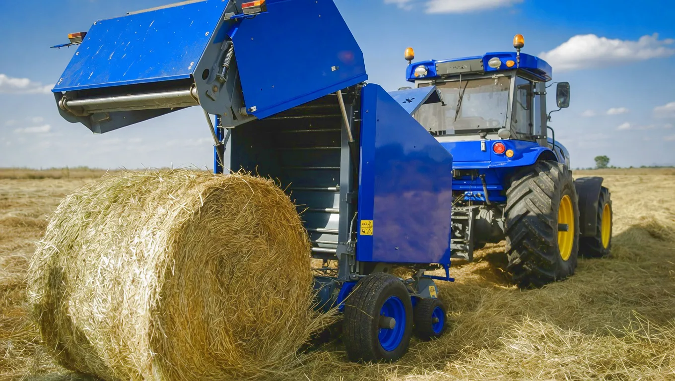 Round baler in field operation UK