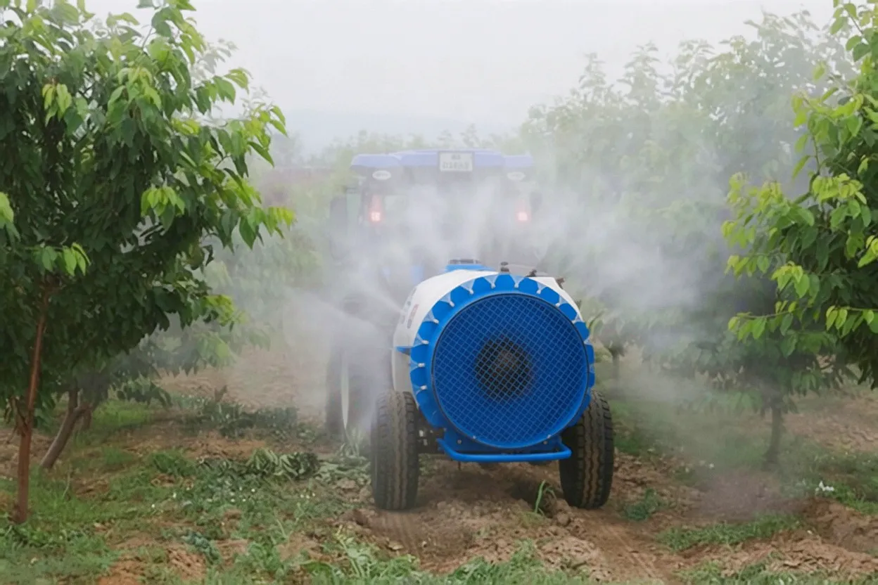 Apple orchard air-blast sprayer in action Kent fruit grower