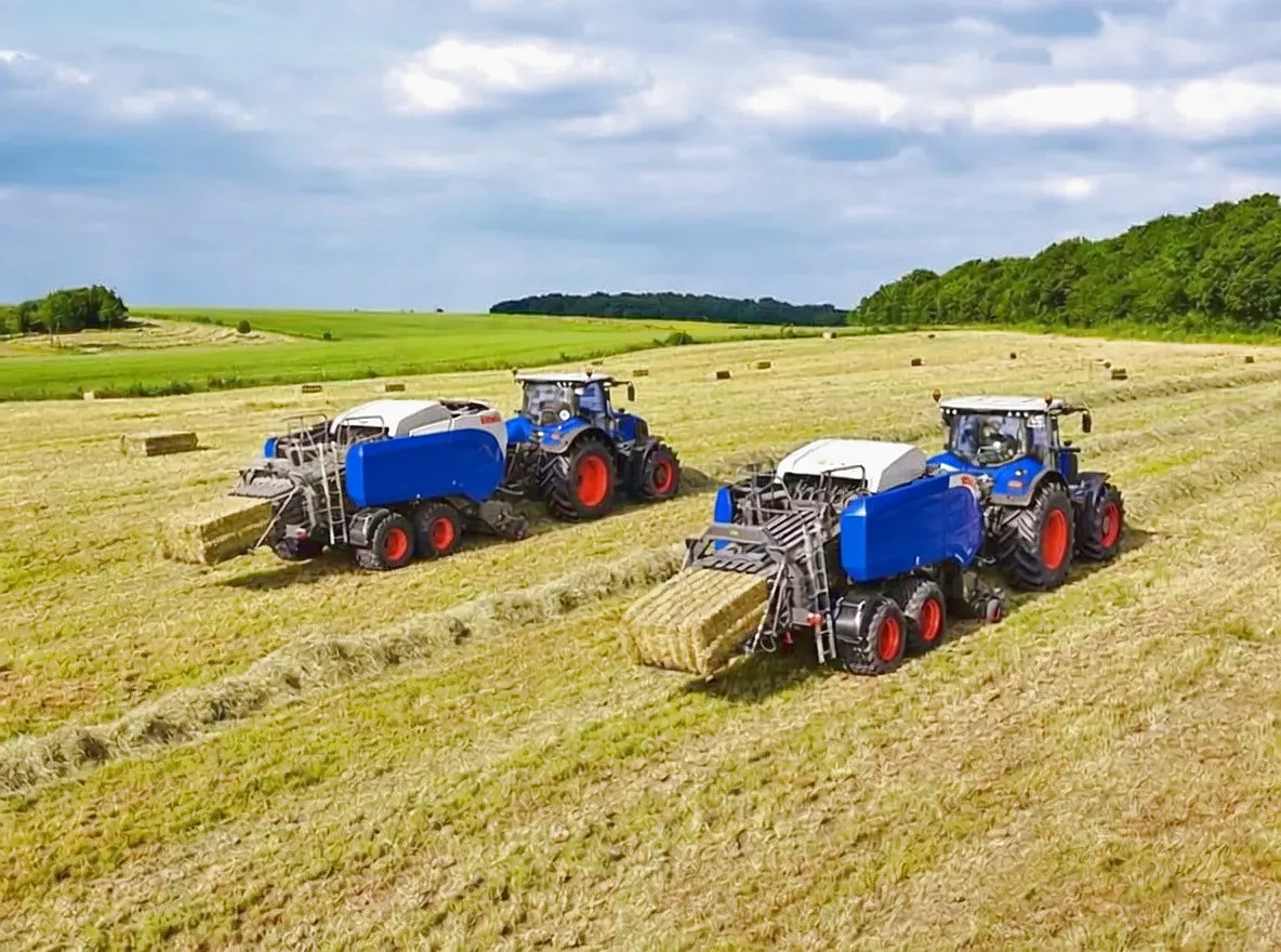 Square baler operating in field - PTO shaft connection visible